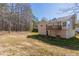 A view of the home's backyard and deck from the far edge of the property at 1059 Buckboard Ct, Douglasville, GA 30134