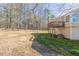 A view of the home's backyard and deck from the far edge of the property at 1059 Buckboard Ct, Douglasville, GA 30134