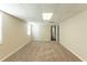 This carpeted basement features neutral paint, a drop ceiling, and access to other areas at 1059 Buckboard Ct, Douglasville, GA 30134