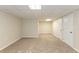 This carpeted basement has neutral paint, a drop ceiling, and several doors for storage and access at 1059 Buckboard Ct, Douglasville, GA 30134