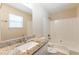 Granite countertop on the vanity complements the bathtub/shower in this bathroom at 1059 Buckboard Ct, Douglasville, GA 30134