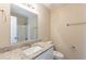 Bathroom showcasing granite countertop, mirror, bathtub/shower, and fixtures at 1059 Buckboard Ct, Douglasville, GA 30134