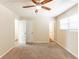 Bright bedroom featuring two entry doors, large window, and plush carpet for comfort at 1059 Buckboard Ct, Douglasville, GA 30134