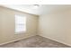 Bedroom features plush carpeting, a window for natural light, and neutral walls at 1059 Buckboard Ct, Douglasville, GA 30134