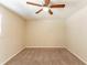 Inviting bedroom featuring a ceiling fan, large window, and plush carpet for comfort at 1059 Buckboard Ct, Douglasville, GA 30134