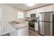 Modern kitchen featuring stainless steel appliances, granite countertops, and ample cabinet space at 1059 Buckboard Ct, Douglasville, GA 30134
