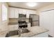 Bright kitchen featuring granite countertops, stainless steel appliances, and updated fixtures at 1059 Buckboard Ct, Douglasville, GA 30134