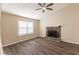 Inviting living room with a stone fireplace, hardwood floors, and a ceiling fan at 1059 Buckboard Ct, Douglasville, GA 30134