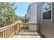 View of the back deck area with wooden railing overlooking lush green trees and natural landscape at 169 Parkview Place Dr, Mcdonough, GA 30253