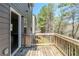 Enjoy the wooden deck that overlooks green trees and lawn, perfect for outdoor relaxation at 169 Parkview Place Dr, Mcdonough, GA 30253