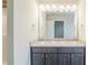 Bathroom featuring double sinks with gray cabinets and large mirror at 169 Parkview Place Dr, Mcdonough, GA 30253