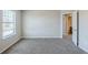 Cozy bedroom with natural light, neutral walls, and gray carpeting at 169 Parkview Place Dr, Mcdonough, GA 30253