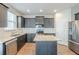 Modern kitchen featuring stainless steel appliances, granite countertops, and dark wood cabinets at 169 Parkview Place Dr, Mcdonough, GA 30253
