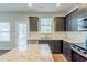 Well-equipped kitchen with stainless steel appliances, granite countertops, and dark cabinets at 169 Parkview Place Dr, Mcdonough, GA 30253