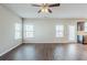 Open-concept living area featuring hardwood floors, a ceiling fan, and a glass patio door at 169 Parkview Place Dr, Mcdonough, GA 30253