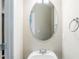 Compact powder room featuring a modern sink with faucet and a round mirror at 169 Parkview Place Dr, Mcdonough, GA 30253