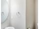 Simple powder room featuring a round mirror, pedestal sink, and neutral walls at 169 Parkview Place Dr, Mcdonough, GA 30253