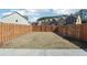 Large, grassy backyard enclosed by a tall, wood fence for privacy and security at 5895 Sheppard Dr, Cumming, GA 30040