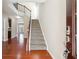 Bright entryway with hardwood floors, staircase, and secure electronic door lock at 5895 Sheppard Dr, Cumming, GA 30040