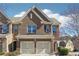 Charming two-story townhome with a two-car garage and brick facade at 5895 Sheppard Dr, Cumming, GA 30040