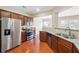 Modern kitchen with granite countertops, stainless steel appliances, and wood cabinets at 5895 Sheppard Dr, Cumming, GA 30040