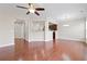Open-concept living area with hardwood floors, ceiling fan, and kitchen view at 5895 Sheppard Dr, Cumming, GA 30040