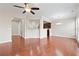 Open-concept living area with hardwood floors, ceiling fan, and kitchen view at 5895 Sheppard Dr, Cumming, GA 30040