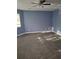 Bright bedroom featuring plush carpeting, a modern ceiling fan, and a sun-soaked window at 851 Hedge Garden Ct, Stone Mountain, GA 30088