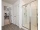 Modern bathroom showcasing glass shower doors and an open walk-in closet at 1042 Edwin Ln, Sugar Hill, GA 30518
