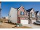 Brick and siding townhome with a two-car garage and a neatly maintained lawn at 1042 Edwin Ln, Sugar Hill, GA 30518