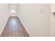Bright hallway with wood-look flooring leading to a front door at 1042 Edwin Ln, Sugar Hill, GA 30518