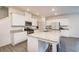 Bright kitchen features white cabinets, stainless steel appliances, granite countertops and a large center island with seating at 1042 Edwin Ln, Sugar Hill, GA 30518