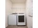 Bright laundry room featuring modern front load washer and dryer with overhead wire rack at 1042 Edwin Ln, Sugar Hill, GA 30518