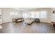 Bright living room with modern furnishings, hardwood floors, and large windows at 1042 Edwin Ln, Sugar Hill, GA 30518