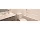 Bright bathroom featuring a white toilet, tub, and sink with neutral walls at 290 Brighton Bend Ln, Acworth, GA 30102