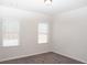 Bedroom featuring two windows with blinds and neutral carpet at 290 Brighton Bend Ln, Acworth, GA 30102