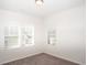 Bedroom featuring three windows with blinds and neutral carpet at 290 Brighton Bend Ln, Acworth, GA 30102