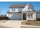 Charming two-story home featuring a white facade, attached garage, and a well-manicured front lawn at 290 Brighton Bend Ln, Acworth, GA 30102