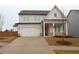 Charming two-story home featuring a white facade, attached garage, and concrete driveway at 290 Brighton Bend Ln, Acworth, GA 30102