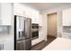Contemporary kitchen featuring stainless steel appliances, sleek white cabinetry, and a subway tile backsplash at 290 Brighton Bend Ln, Acworth, GA 30102