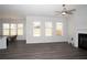 Spacious living room featuring a fireplace, neutral walls, wood-look floors, and large windows at 290 Brighton Bend Ln, Acworth, GA 30102