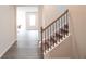 Hallway with hardwood floors leading to a staircase with dark metal spindles at 290 Brighton Bend Ln, Acworth, GA 30102