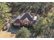 Aerial view of brick home with red shutters, circular drive, and private wooded lot at 440 Dix Lee On Dr., Fayetteville, GA 30215