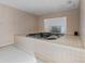 Spacious bathroom with a large tiled whirlpool tub and glass block window feature for natural light at 440 Dix Lee On Dr., Fayetteville, GA 30215