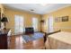Inviting bedroom with hardwood floors, shutters and warm, sunny, yellow walls at 440 Dix Lee On Dr., Fayetteville, GA 30215