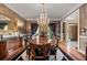 Elegant dining room with dark wood floors, a chandelier, and a large dining table at 440 Dix Lee On Dr., Fayetteville, GA 30215