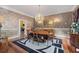 Formal dining room with decorative wallpaper, a chandelier, and a large wooden table at 440 Dix Lee On Dr., Fayetteville, GA 30215