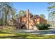 Brick two-story home with a deck and a two-car garage with lush landscaping at 440 Dix Lee On Dr., Fayetteville, GA 30215