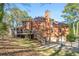 Rear exterior view of a brick two-story home with deck and two car garage at 440 Dix Lee On Dr., Fayetteville, GA 30215