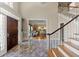 Grand foyer featuring marble floors, a staircase, and a glimpse into the living room at 440 Dix Lee On Dr., Fayetteville, GA 30215